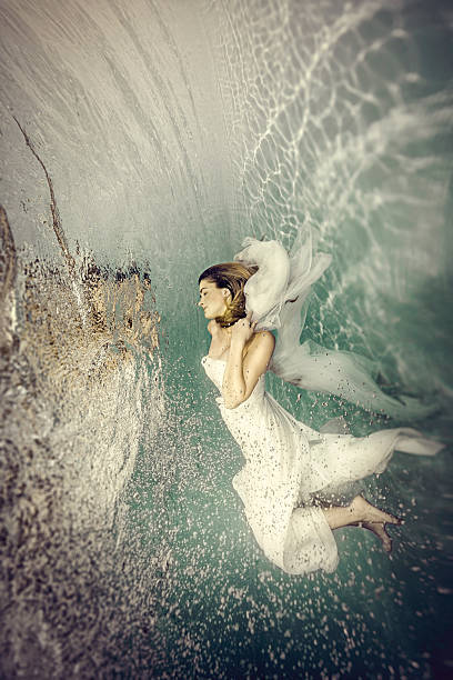 Young bride dancing underwater